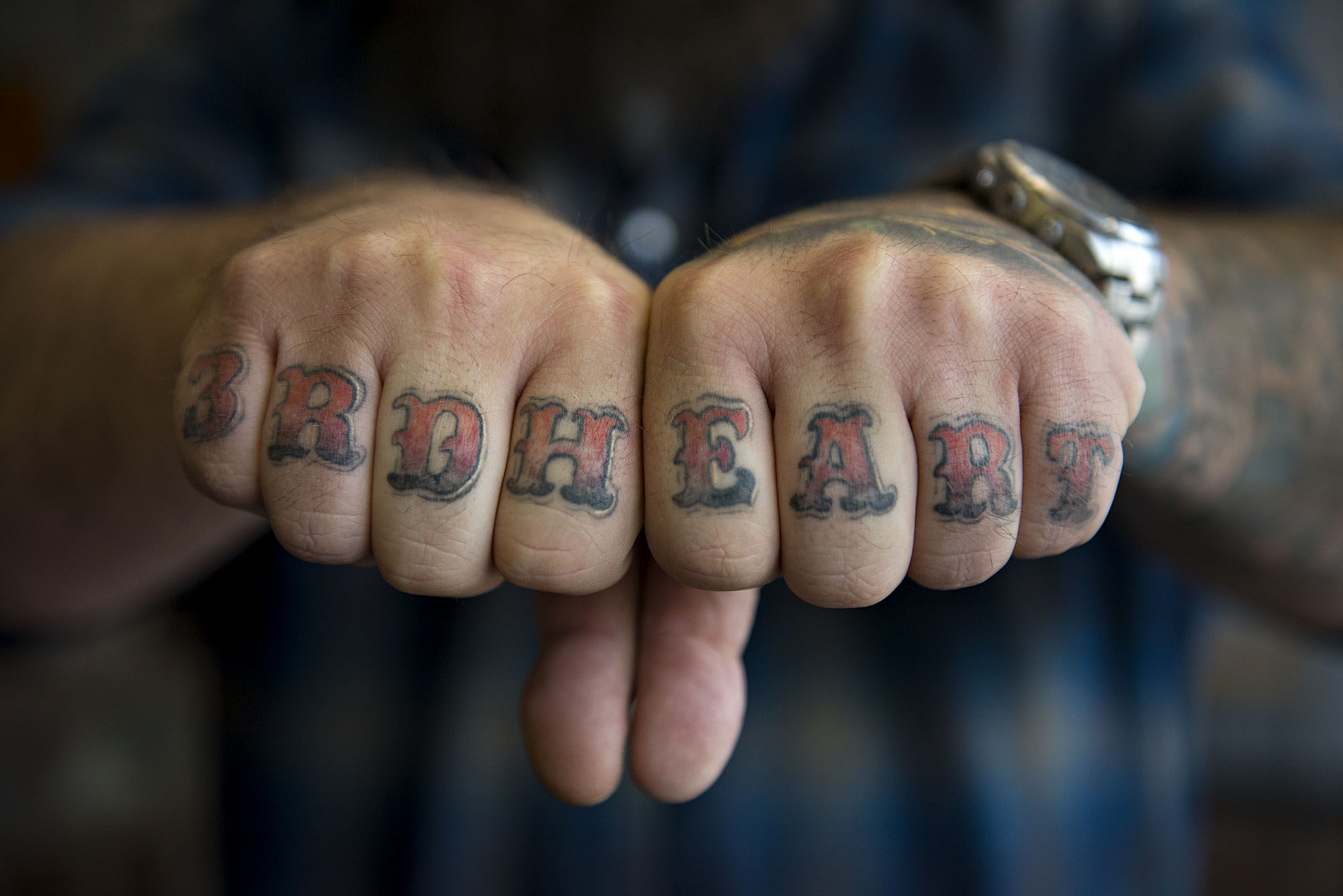 Tattoo artist Ryan "Boomer" Boomhower displays tattoos on his knuckles Tuesday afternoon, Oct. 6, 2015 in Washougal. (Amanda Cowan/The Columbian)