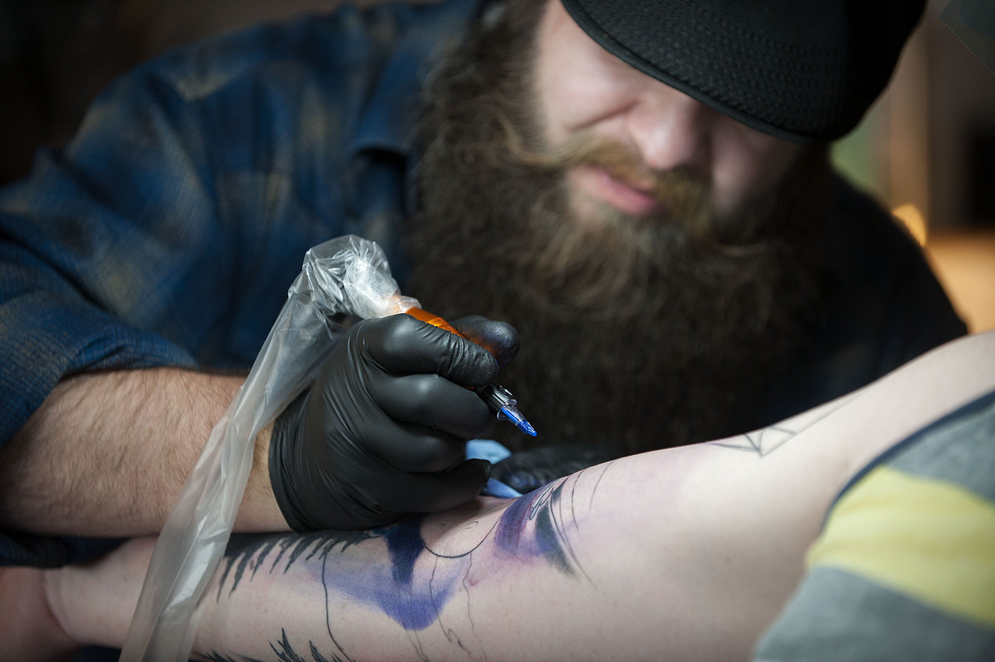 Tattoo artist Ryan "Boomer" Boomhower creates a tattoo with a Columbia River Gorge theme for customer Joel Schmid of Camas at 3rd Heart Tattoo on Tuesday afternoon, Oct. 6, 2015 in Washougal. (Amanda Cowan/The Columbian)