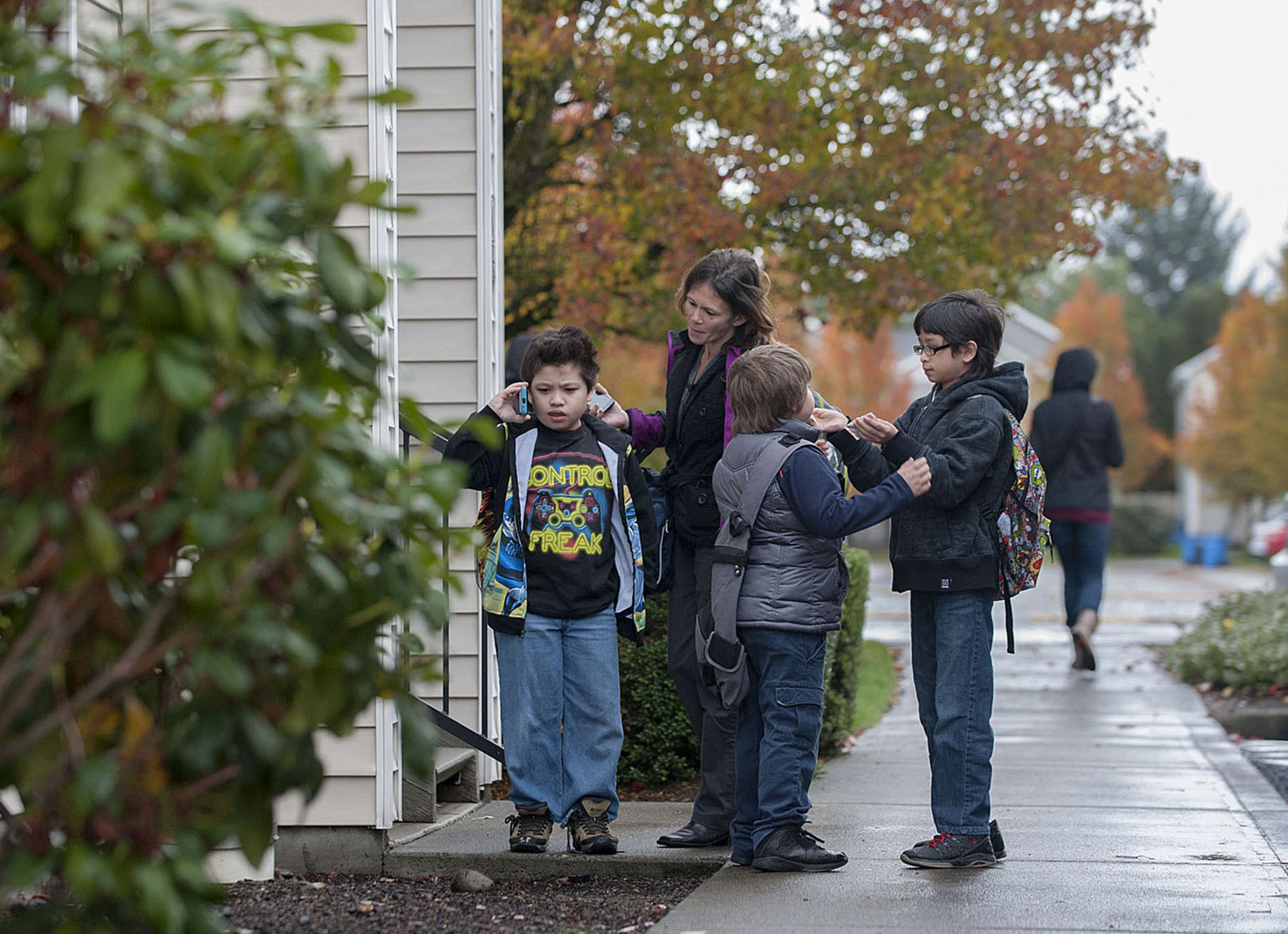 Tensions rise between Ozzy Pinaula, 9, from left, and his mom, Donna, before school as his brothers Johnny Pinaula, 7, and Robert Pinaula, 10, look on Tuesday morning, Nov. 17, 2015 in Orchards. (Amanda Cowan/The Columbian)