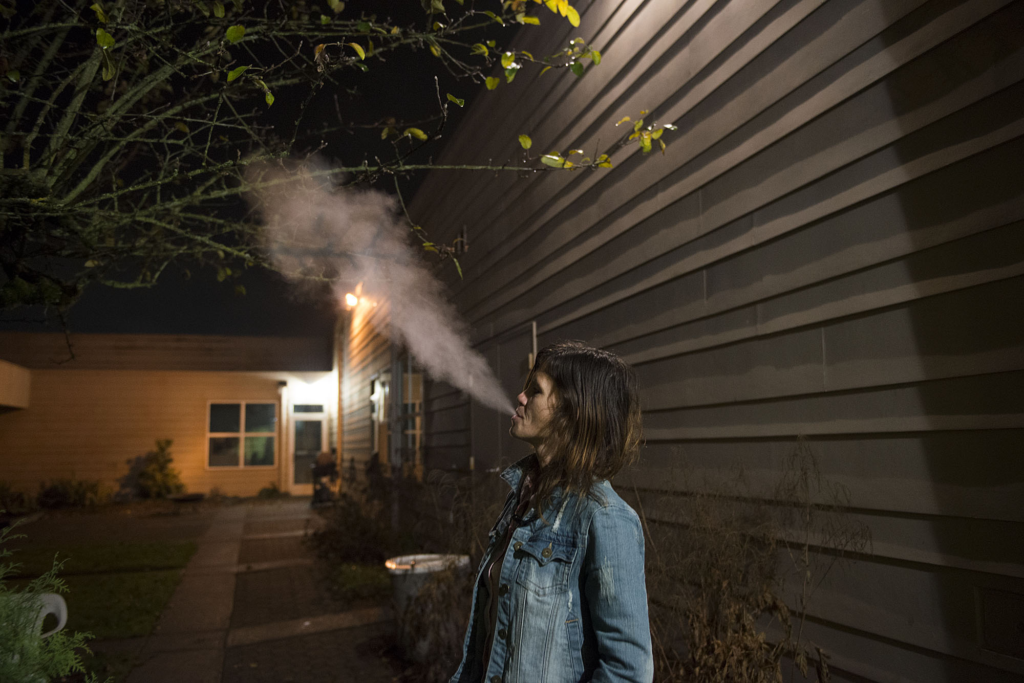 Donna Pinaula takes a few moments to herself to relax and smoke outside while her children shower Wednesday night, Dec. 2, 2015 at St. Andrew Lutheran Church. Although she has been smoking since she was a teenager, she said she tries not to smoke around her kids. (Amanda Cowan/The Columbian)
